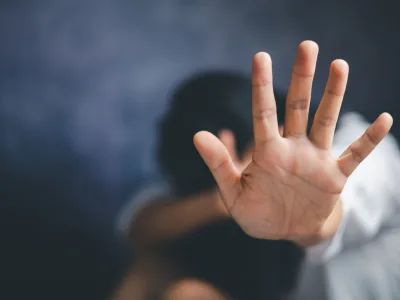Close-up of a hand raised in defense, symbolizing domestic violence protection and support.