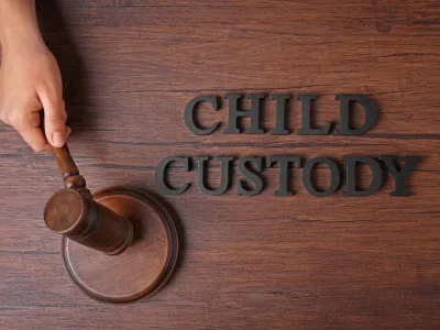 Child custody text with a judge's gavel on a wooden surface.